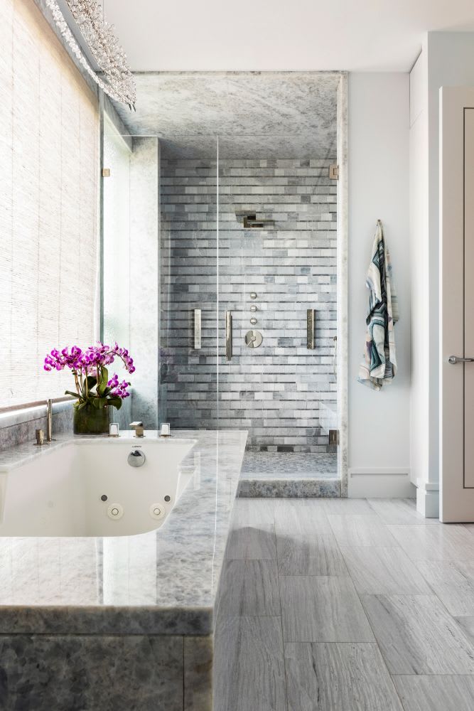 shower and tub of the luxury master bath of a belfiore houston residence