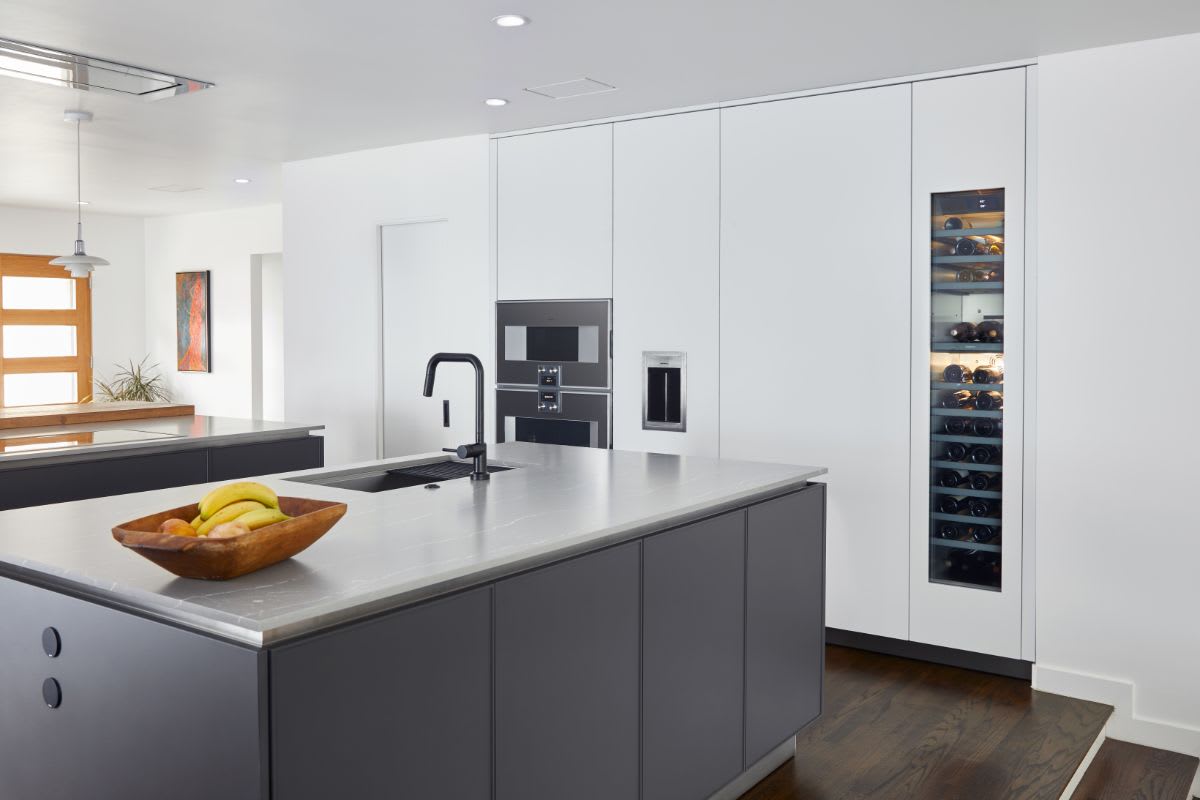wall of tall ultra-modern cabinets with integrated appliances designed by eggersmann for a mid-century oak cliff home in dallas texas