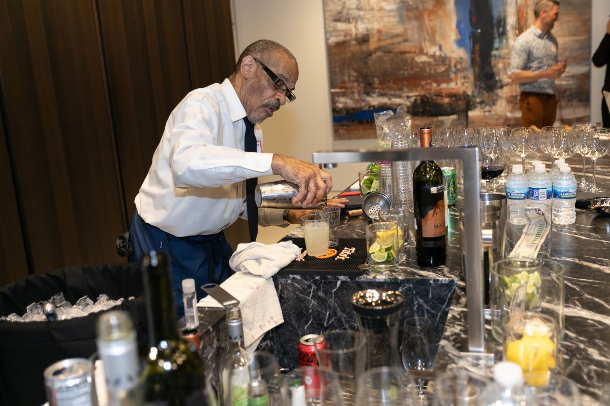 bartender crafting cocktails at chicago lgbtqia spring social in the eggersmann showroom in rndd