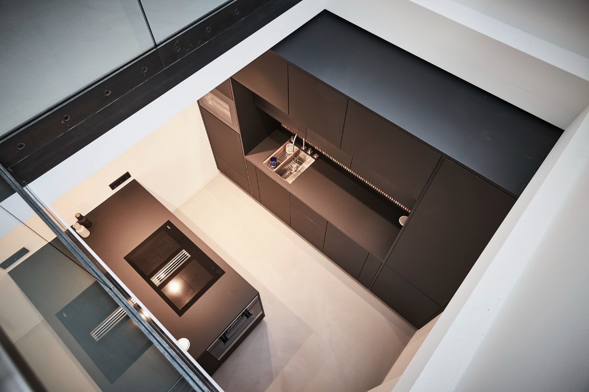 a minimalist zen design was used by eggersmann for this kitchenette tucked into a nook