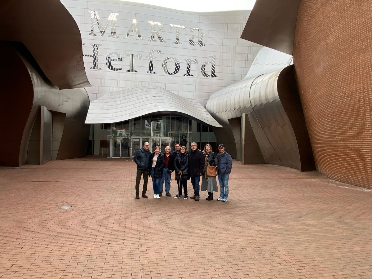 anne breux with a design team from texas in front of the MARTa museum in herford germany that was designed by frank gehry
