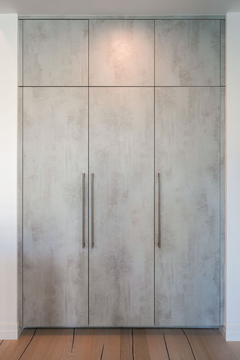 tall cabinets with a concrete finish in a luxury beverly hills home