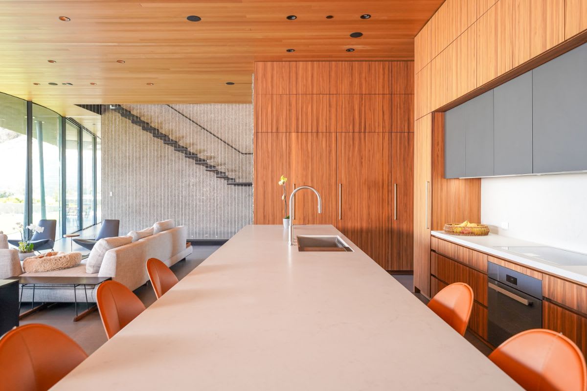 caesarstone island counter top with stainless steel sink and gooseneck fauct in an eggersmann-designed luxury kitchen in a home in the pacific palisades