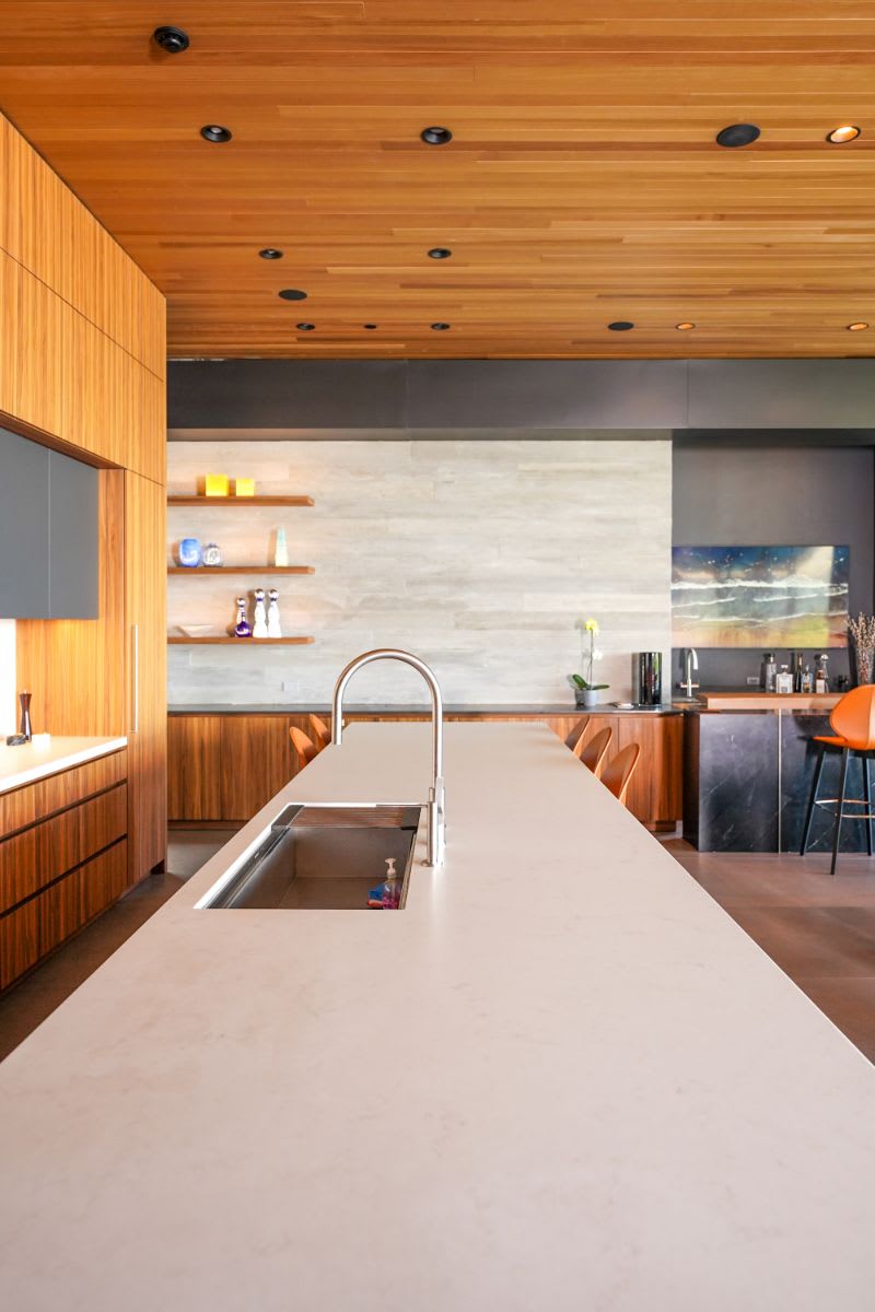 caesarstone london grey island counter top with stainless steel sink and gooseneck fauct in an eggersmann-designed luxury kitchen in a home in the pacific palisades