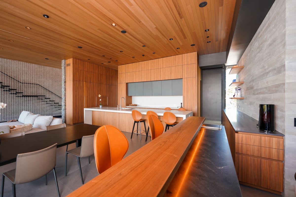 pacific palisades home's great room with eggersmann-designed kitchen, butlers' pantry, and bar with mini home office