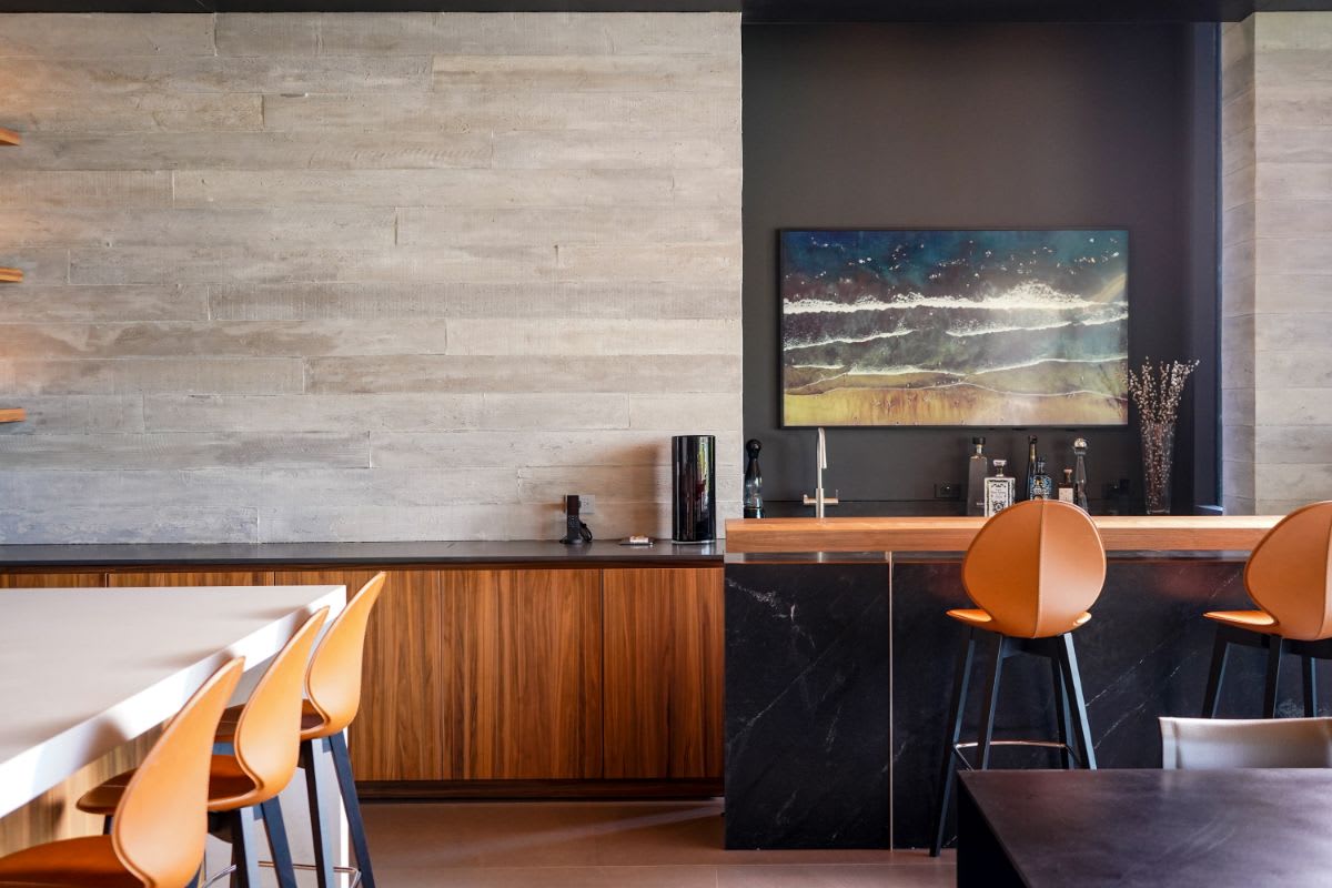 pacific palisades home's great room with eggersmann-designed bar with mini home office cabinet
