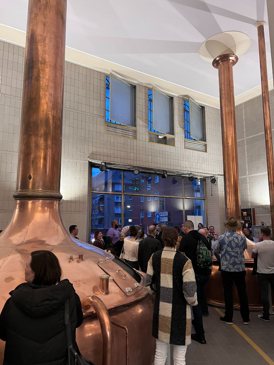 a tour group inside the Rheinauhafen's Brauwelt Koln, one of the oldest breweries in Cologne