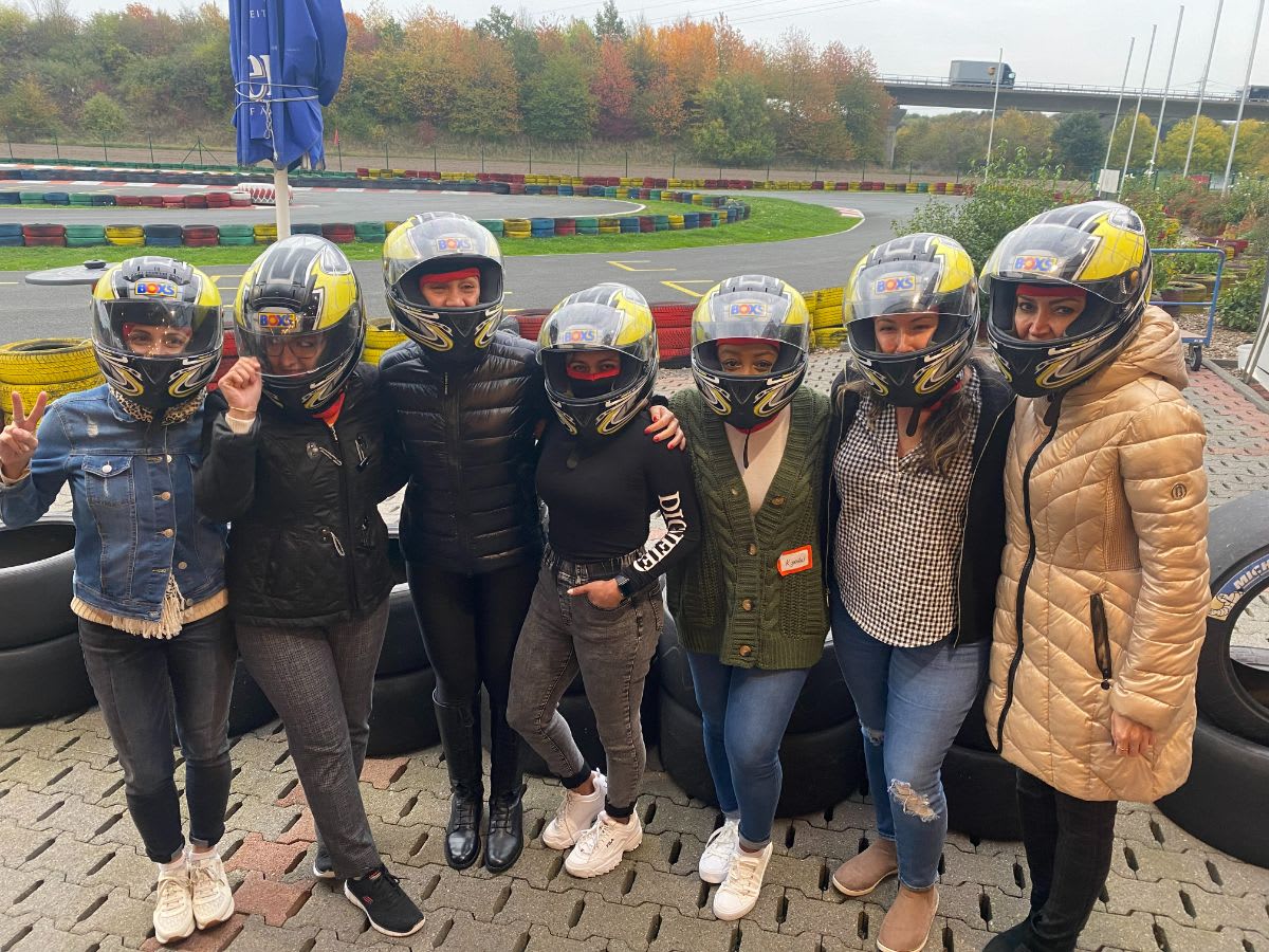 the 2022 eggersmann factory tour group in helmets ready for their go-kart race track experience