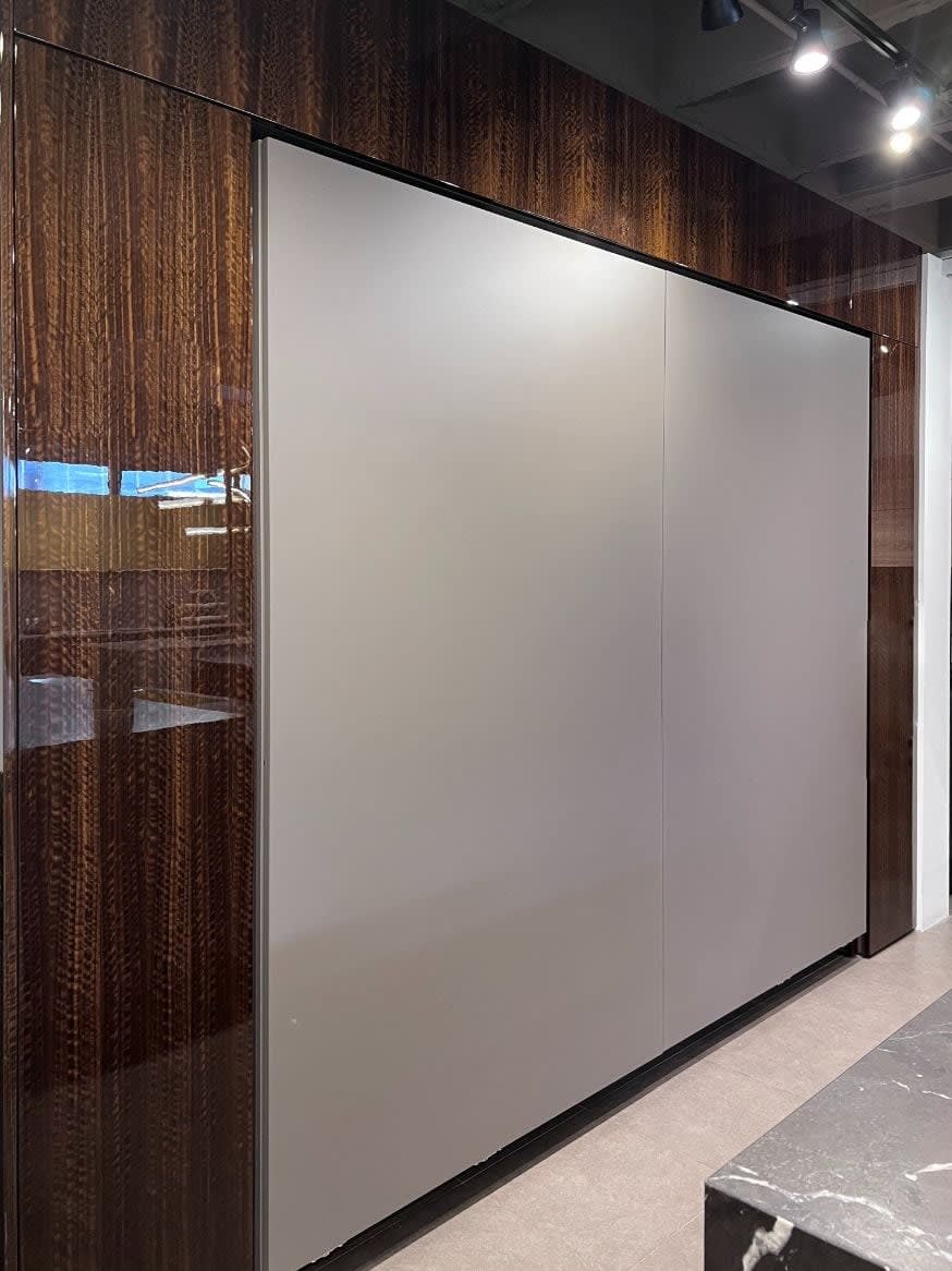 coplanar doors in Satin lacquer Umbra color that hide a wet bar and a snack/coffee bar in eggersmann new york's new kitchen display