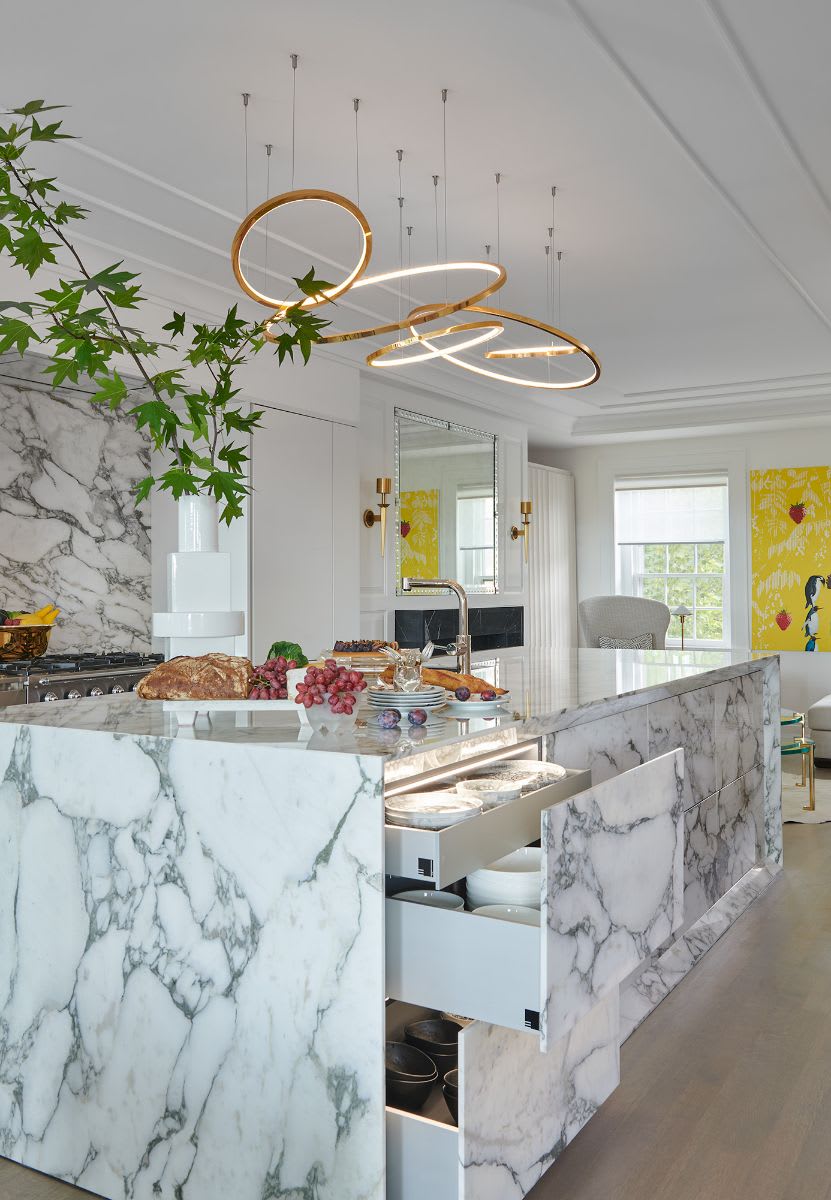 drawers open in a bauhaus inspired monolithic stone kitchen island in a kitchen designed by eggersmann for a georgetown washington dc penthouse