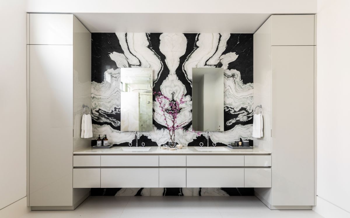 eggersmann-designed luxury floating vanity with bookmatched marble backsplash in the master bath of a new construction home in the tanglewood community of houston texas