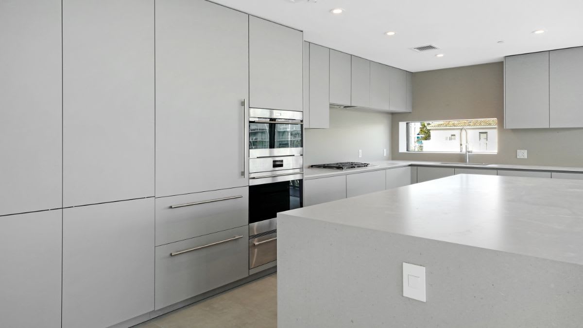 all-gray kitchen with high-end appliances designed by eggersmann for a one24 residences penthouse in fort lauderdale florida