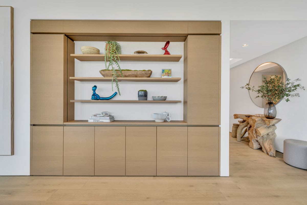 built-in luxury display shelving and storage of a 8899 beverly blvd living area in decor elm finish