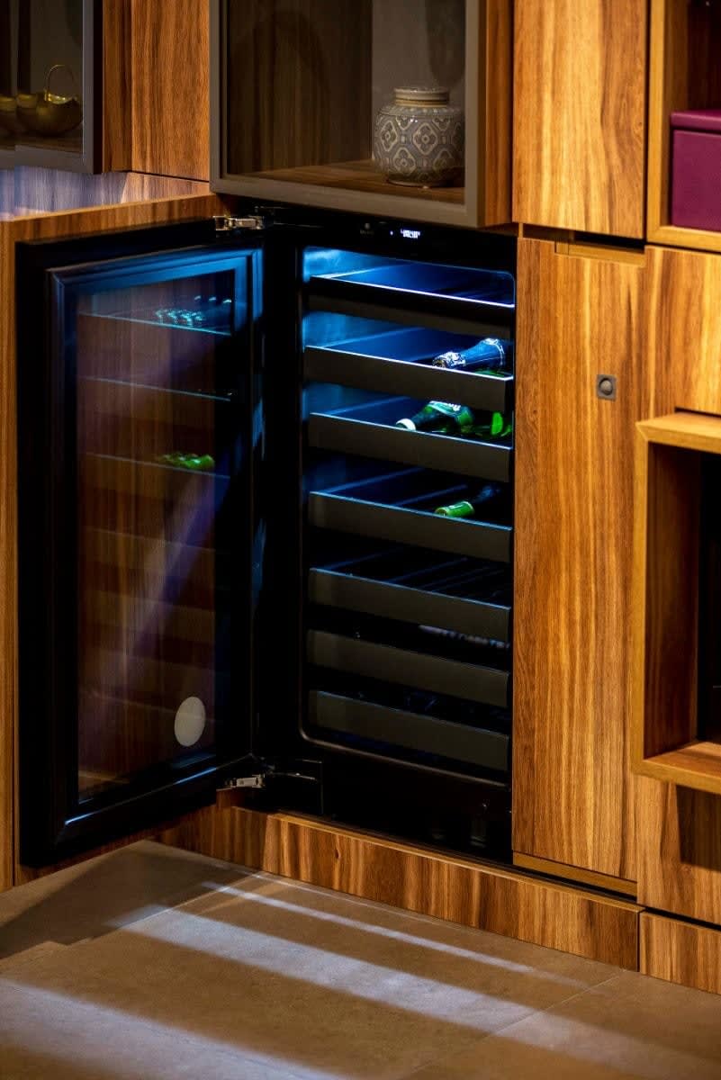 integrated wine fridge ina luxury bar area by a fireplace in a living room