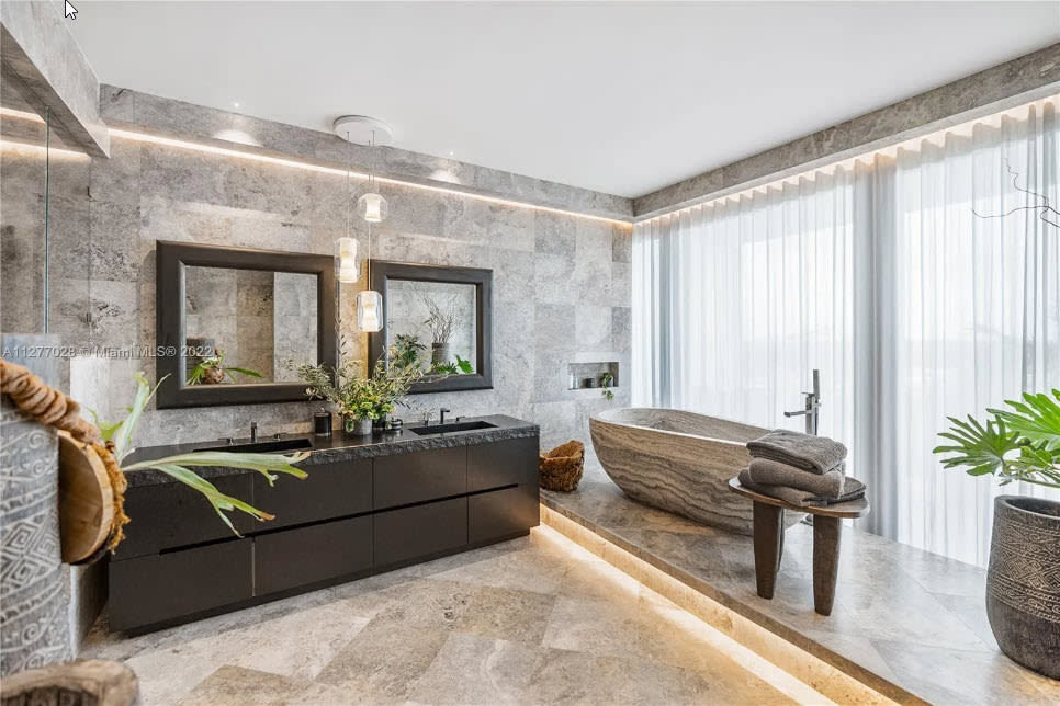 floating double vanity in a custom dark lacquer in a four seasons residence of the surf club