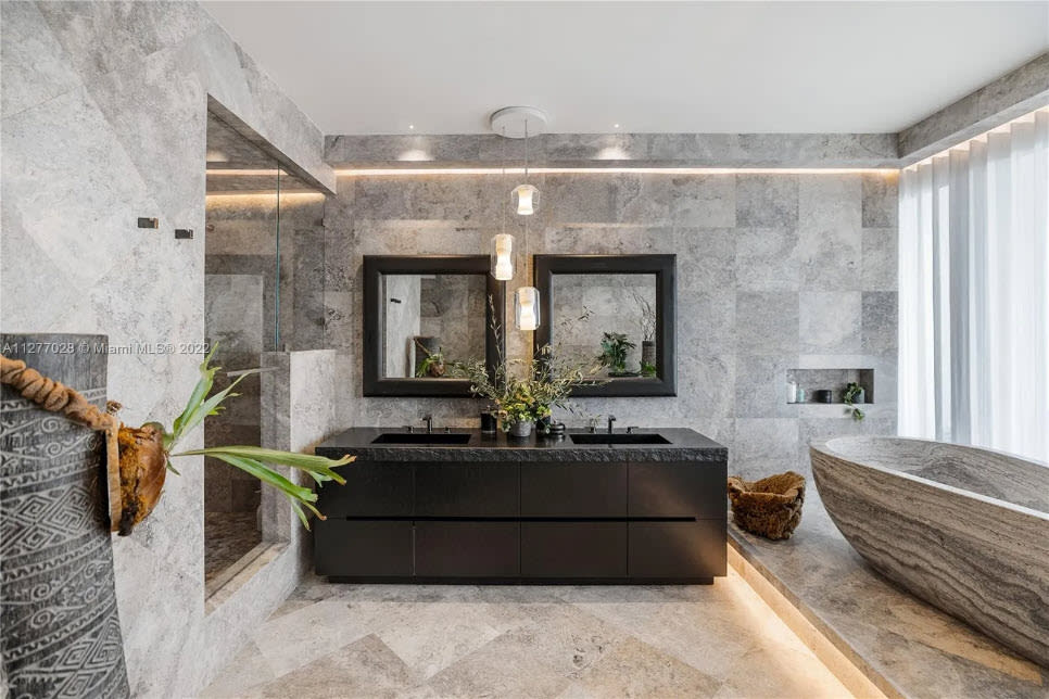 floating bath vanity in a custom dark lacquer in a four seasons residence of the surf club