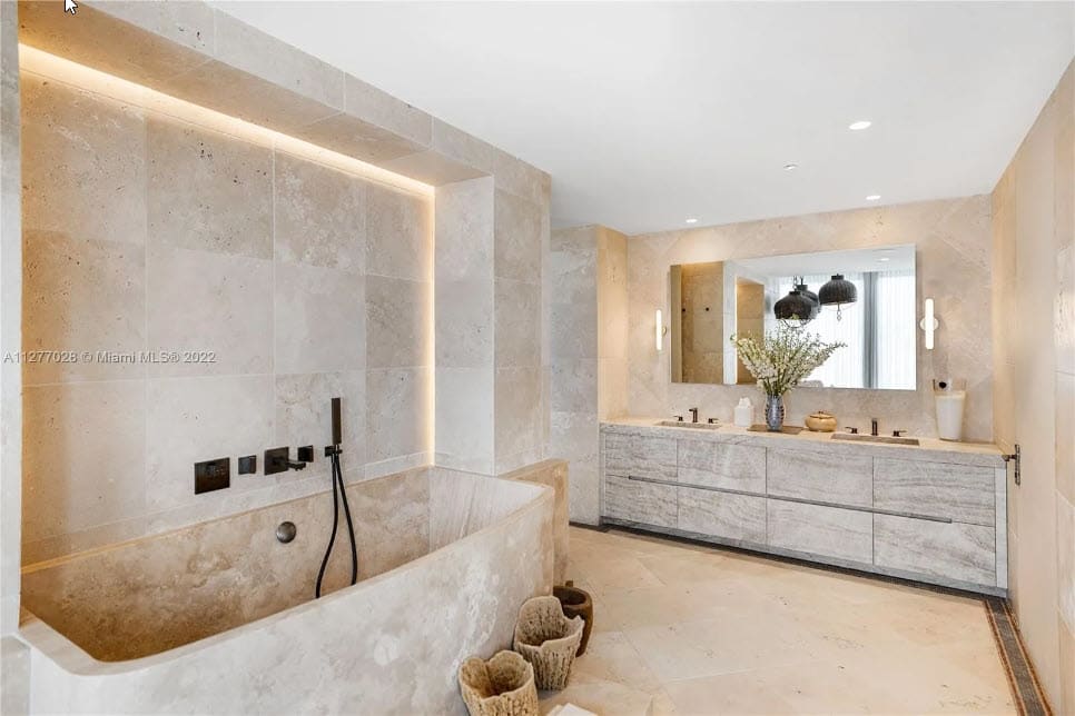 floating bath vanity in a custom antique white stained oak veneer in a four seasons residence of the surf club