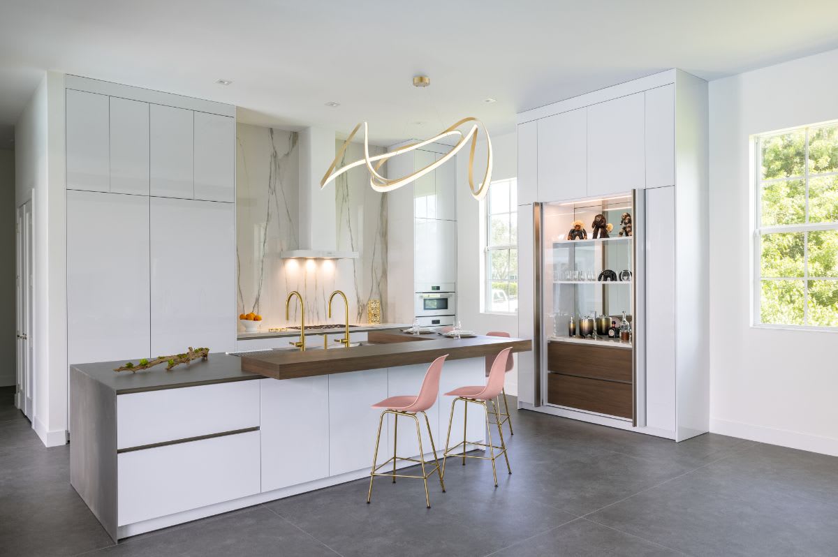 jupiter fl luxury white kitchen with hideaway bar with pocket doors open