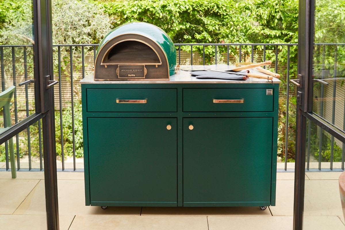 small outdoor kitchen mobile unit in green gloss with pizza oven designed by michael aiduss design