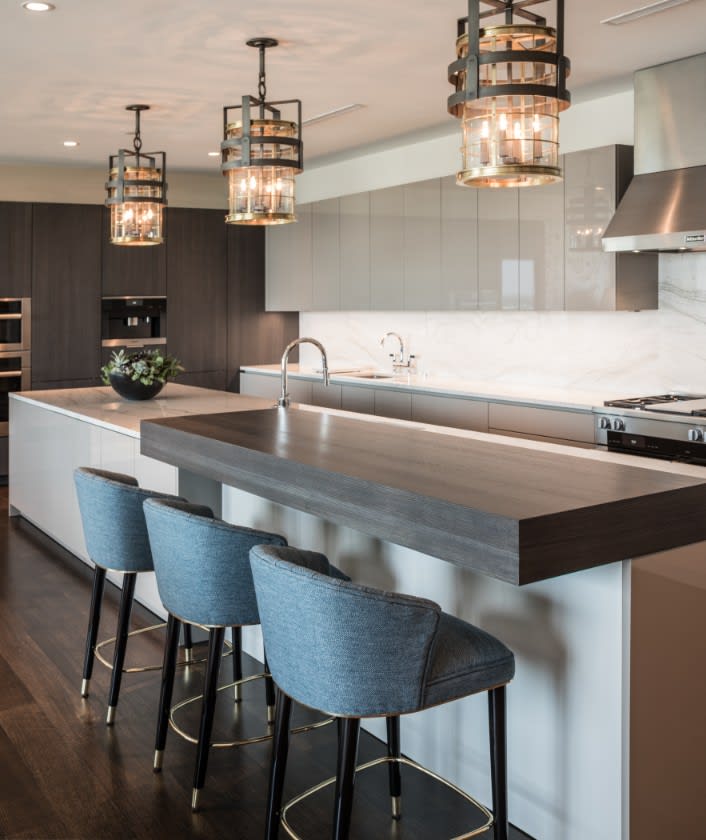 belfiore 21st floor residence luxury transitional white clad kitchen island features a contrasting dark walnut dining bar