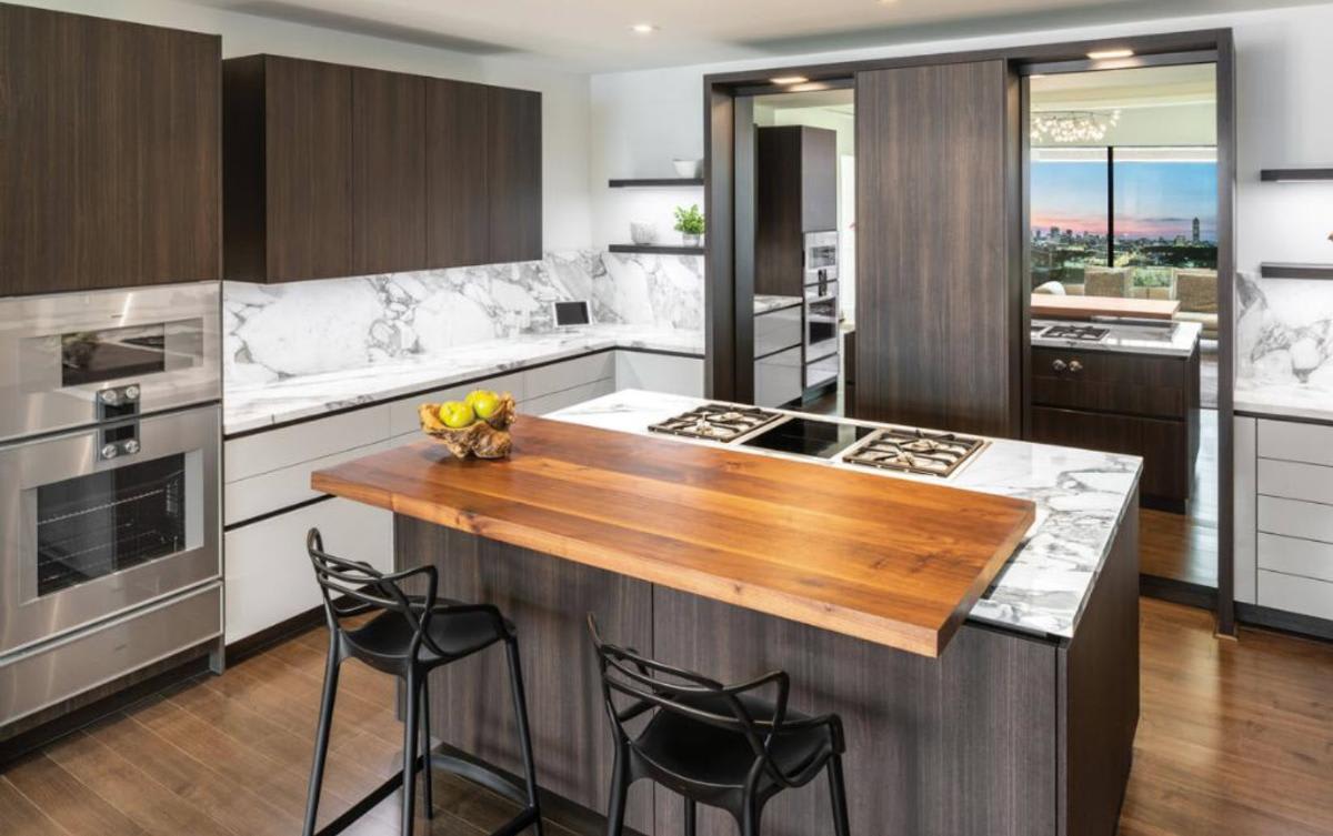 houston's london house mid-rise luxury kitchen with wood breakfast bar designed by eggersmann