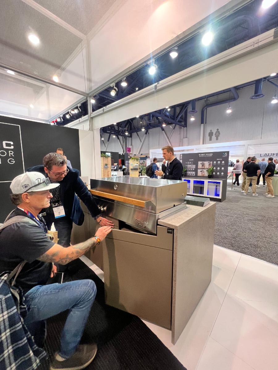 visitors exploring eggersmann outdoor living kbis 2024 booth's kitchen in a cabinet