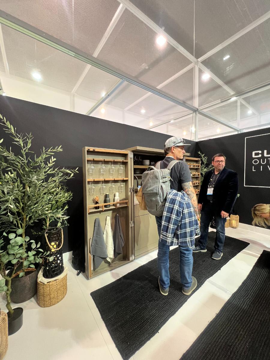 visitors exploring eggersmann outdoor living kbis 2024 booth's bar in a cabinet