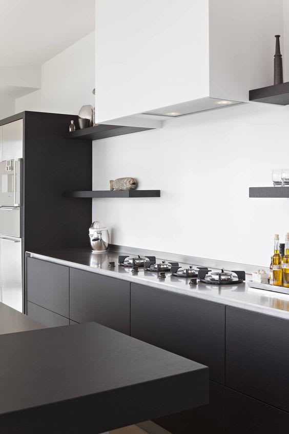 closeup of pitt cooking integrated gas burners in ebony cabinets with white countertop