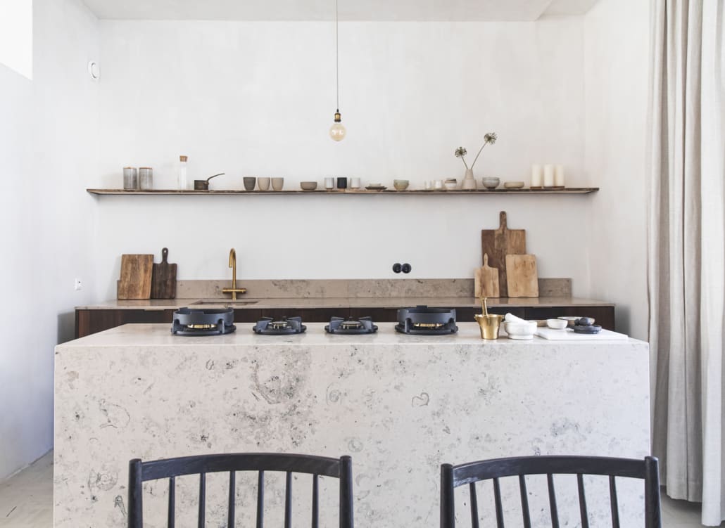 pitt cooking custom integrated gas burners in white stone kitchen island in a minimal kitchen