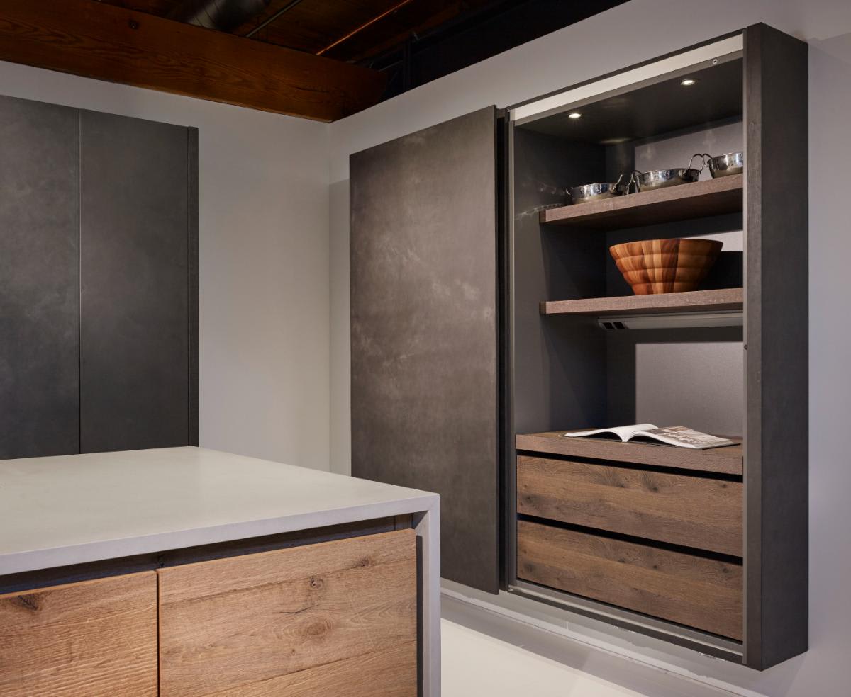 closeup of dark grey wall-mounted cabinet unit with coplanar doors open