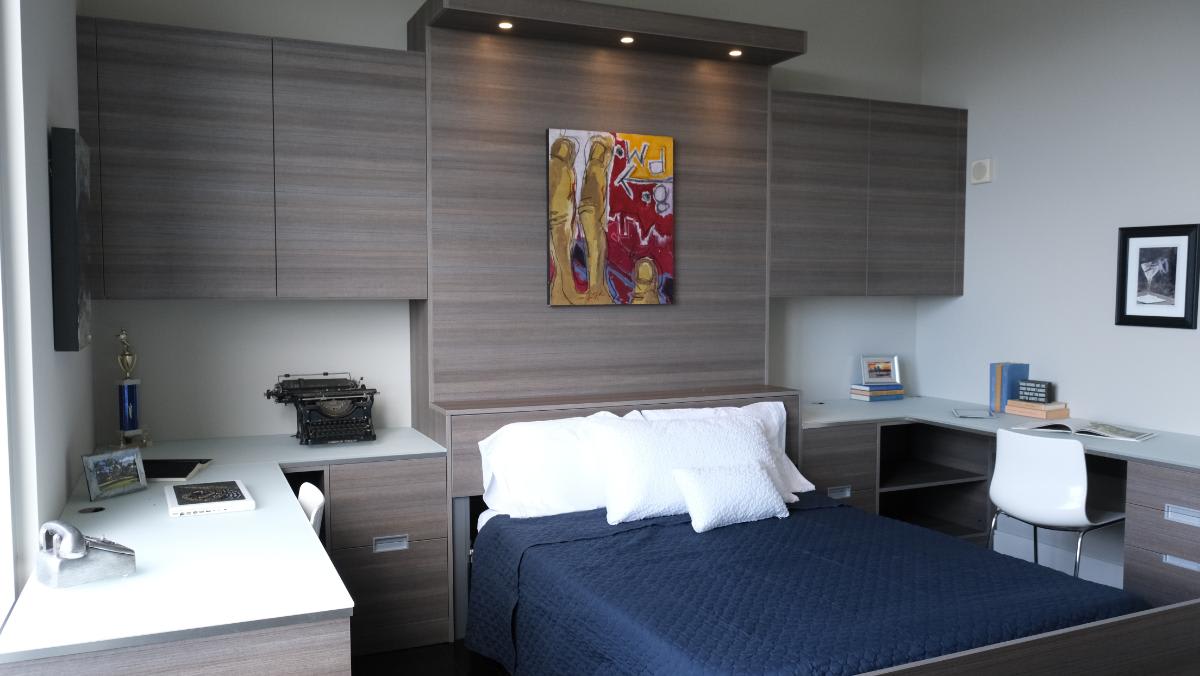 luxury office cabinetry featuring a hideaway rollup bed designed by eggersmann to add flexibility for guests