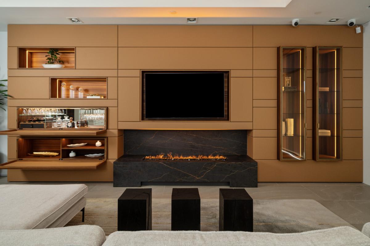 upholstered media wall display with fireplace, art niches, and tv in the eggersmann laguna showroom