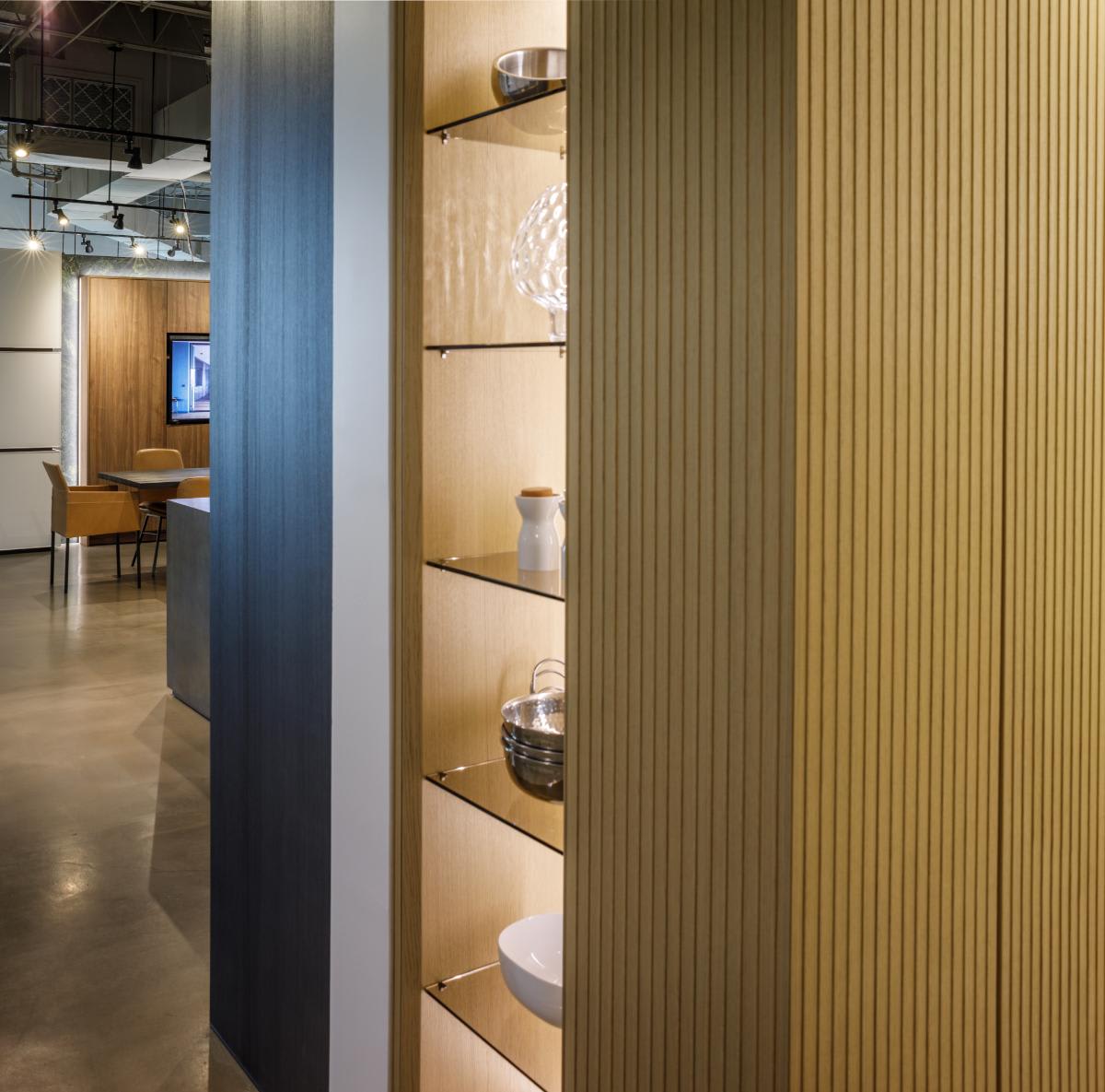 glow cabinetry unit close to the wood veneered closed storage side of the glow cabinetry unit osaka luxury wood veneer kitchen display in the eggersmann houston showroom