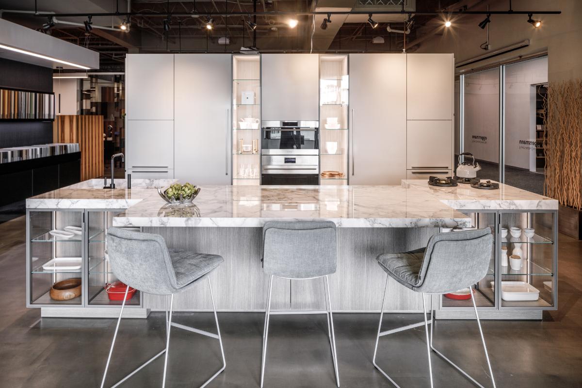 white gloss wall cabinets and glance glass display kitchen with motion sliding countertop extended in the eggersmann houston showroom