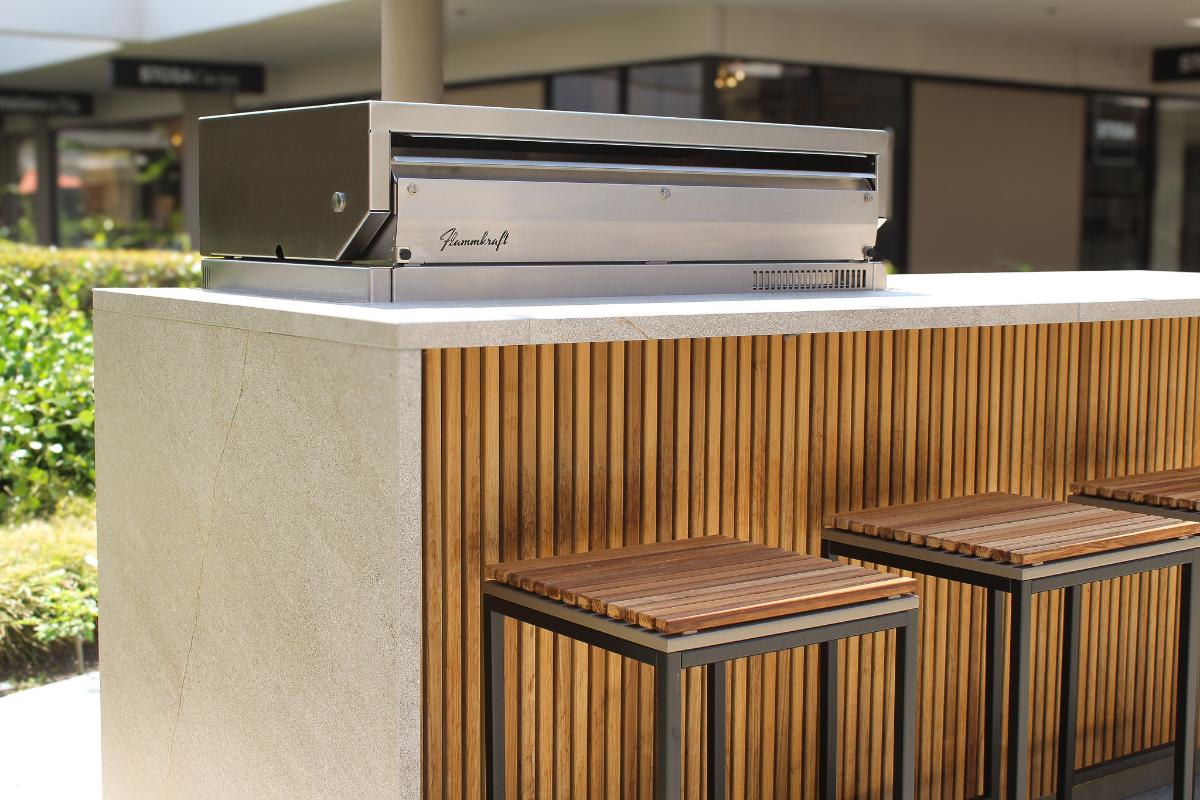 close up of the luxury outdoor kitchen island bar with stools outside eggersmann Laguna showroom