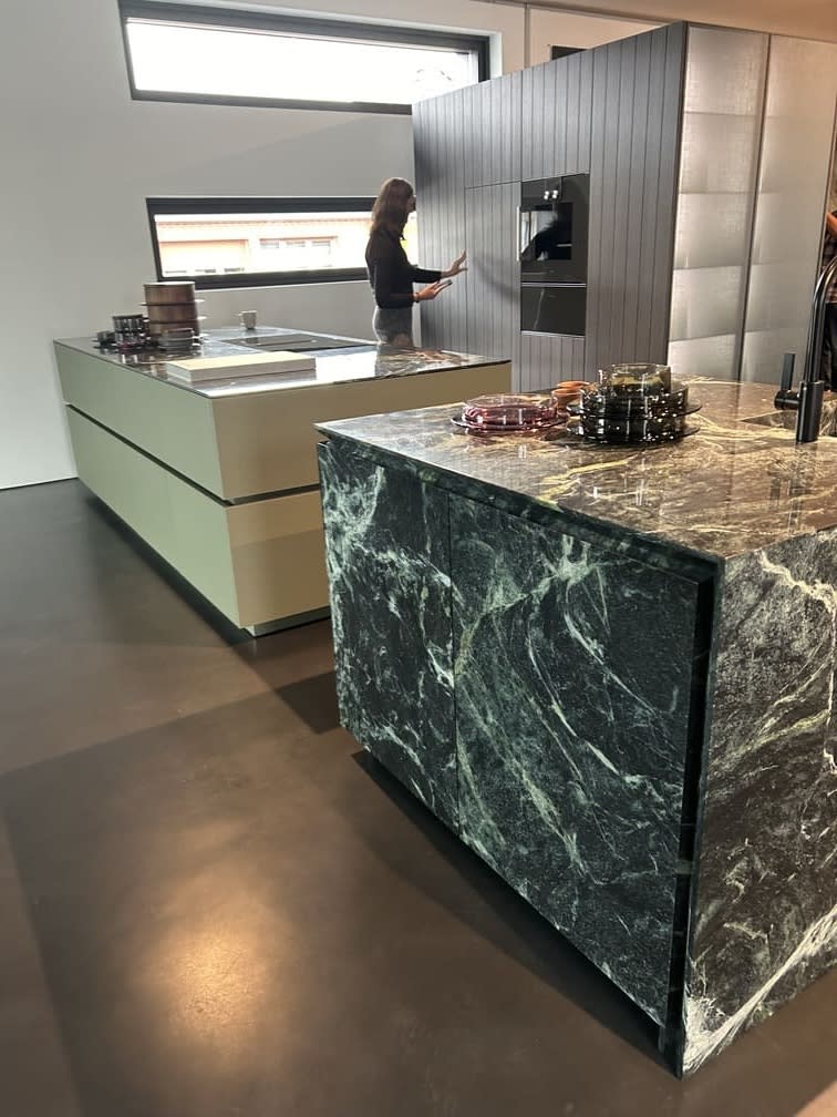twin islands in tauern green palette with granite and portland linoleum cladding in the eggersmann showroom in hiddenhausen germany during the eggersmann usa concierge trip to german factories in fall 2024