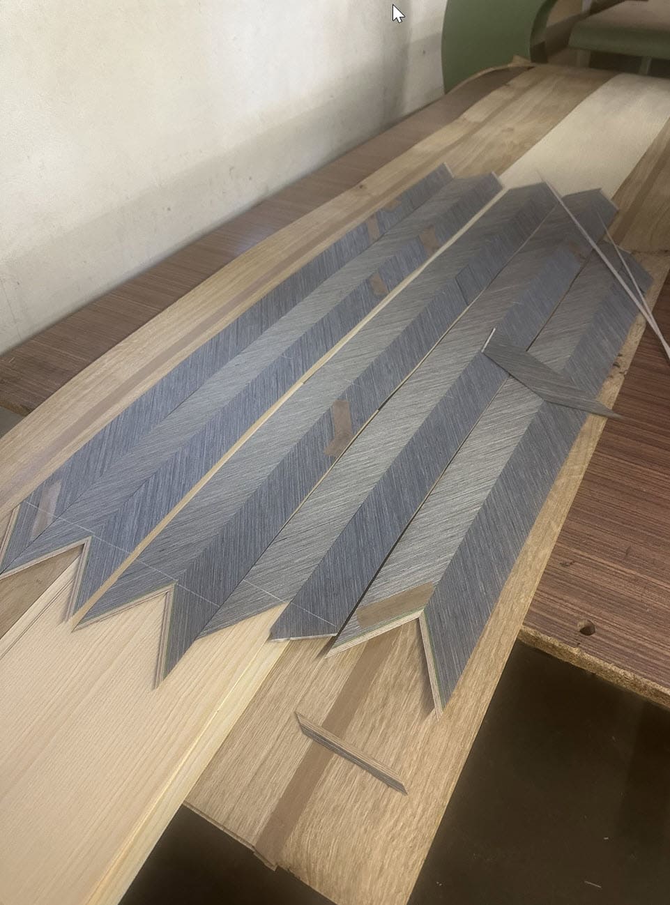 herringbone wood veneer pattern created by veneer artisans in eggersmann's veneer shop in germany