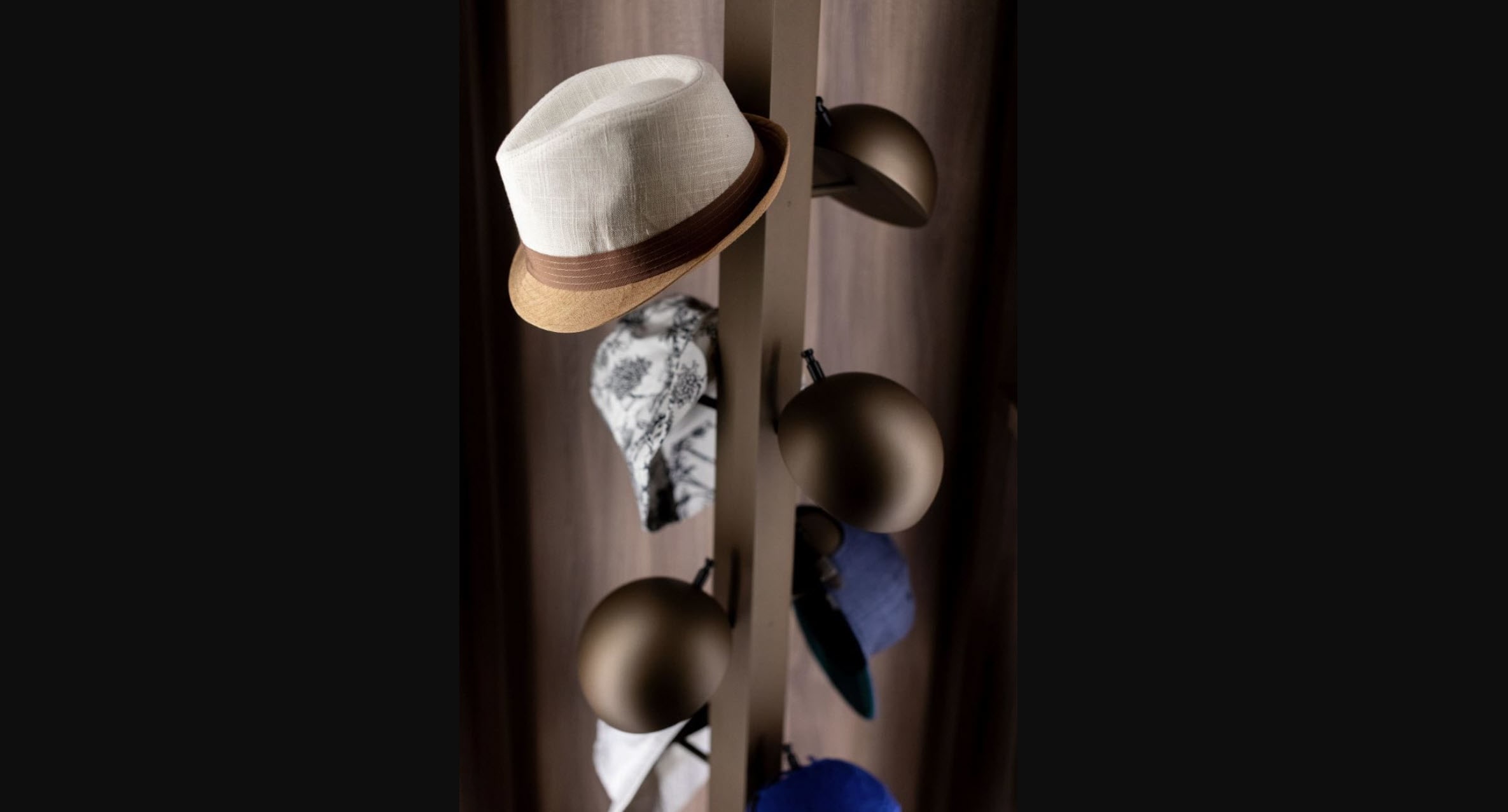 closeup of a eggersmann-designed custom revolving hat storage tower in a luxury walk-in wardrobe