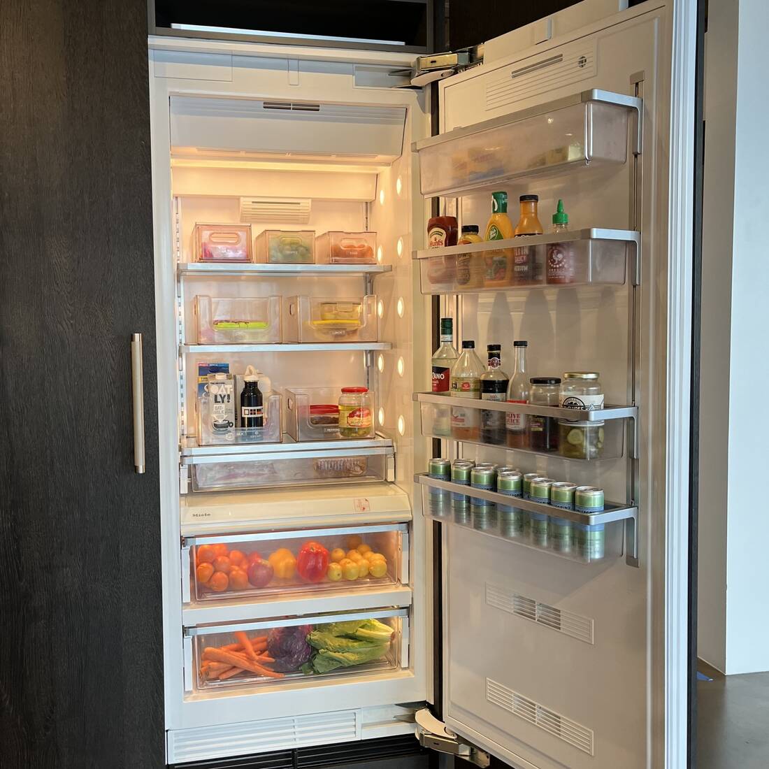 open refrigerator stocked with healthy whole foods