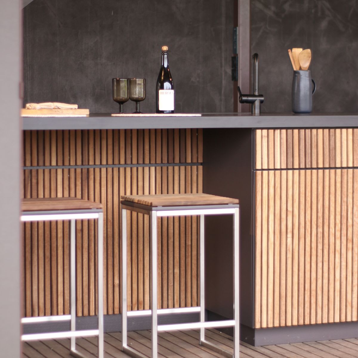 bar seating in an outdoor kitchens encourage gather in nature for a higher level of wellness