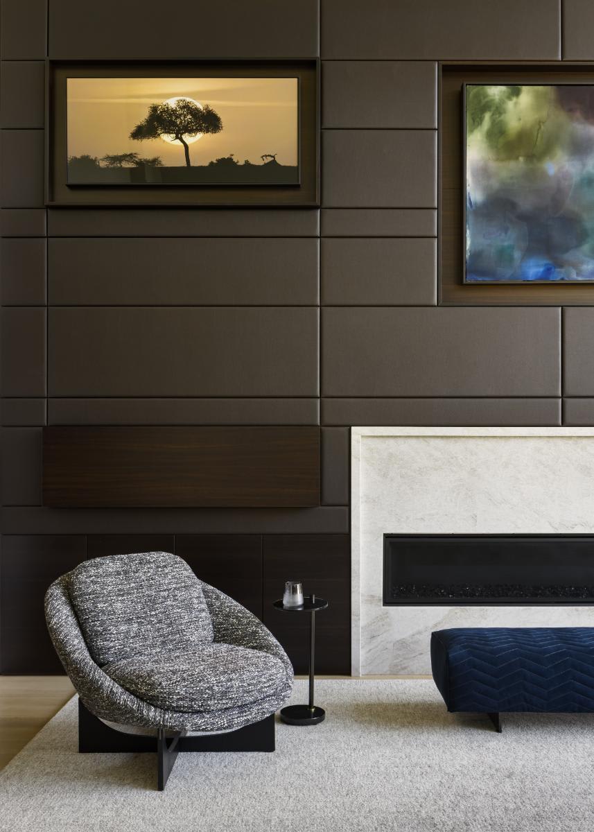 tv hidden and flip-down bar closed in a eggersmann-designed media wall of a luxury home living room in a home in leawood kansas