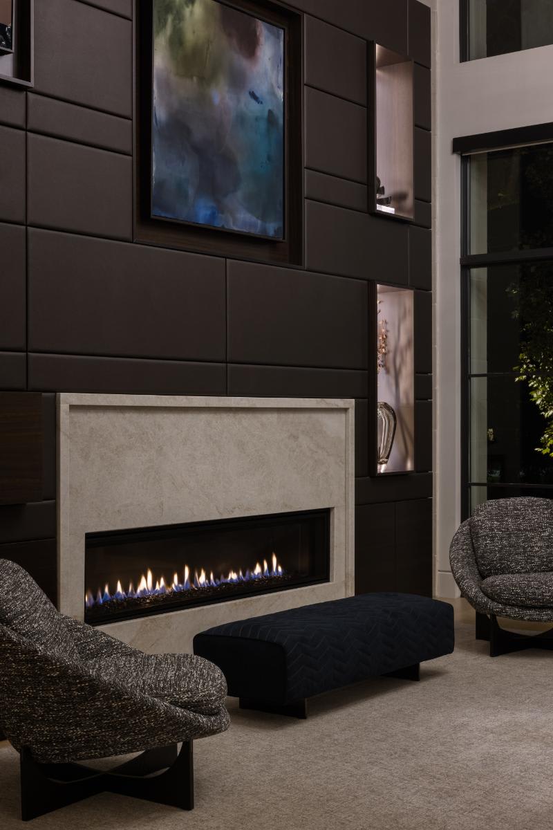 lit fireplace of an eggersmann-designed media wall in a luxury home living room of a home in leawood kansas