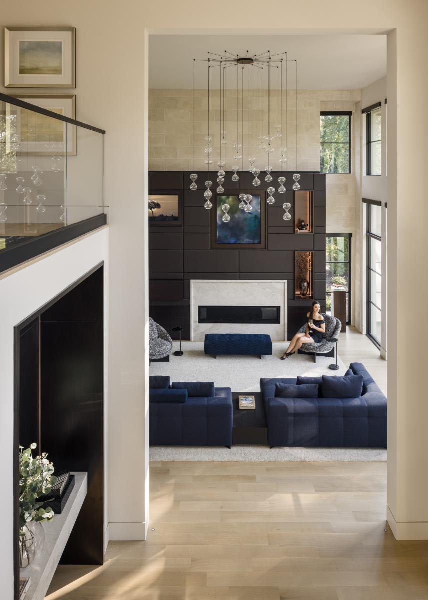 eggersmann-designed media wall seen from the foyer of a luxury home living room in a home in leawood kansas