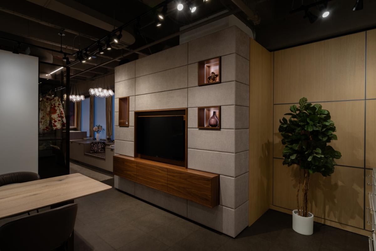 side view of a eggersmann nyc showroom media wall display with the storage and table top console closed
