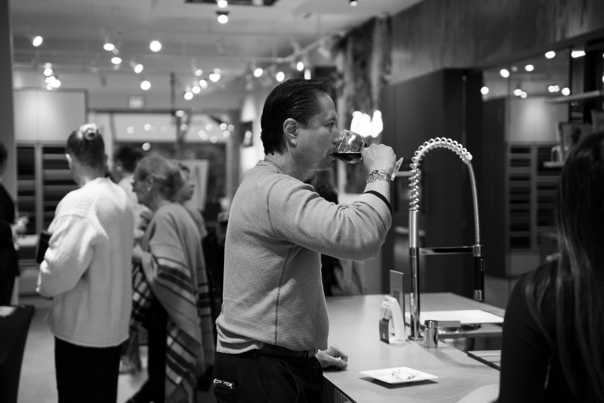 attendee sipping wine in a display kitchen at design west hollywood 2025 in the eggersmann la showroom