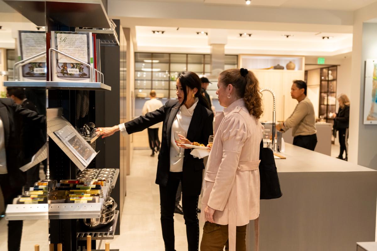 attendees examining the works turnstile pantry features of a display kitchen in the eggersmann la showroom during design west hollywood 2025