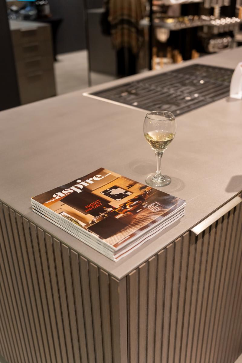 stack of aspire magazines, event co-sponsor, in a display kitchen in the eggersmann la showroom during design west hollywood 2025