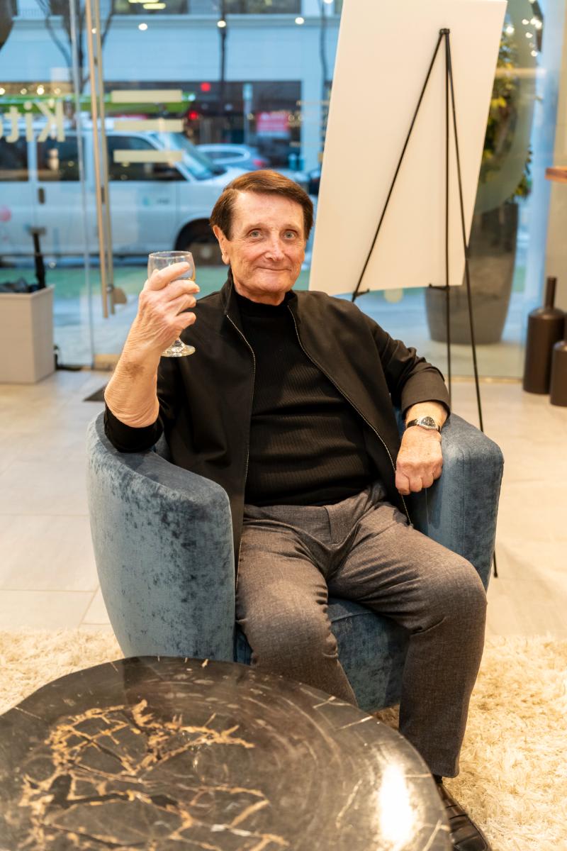 attendee enjoying a glass of wine in home living display area of the eggersmann la showroom during design west hollywood 2025