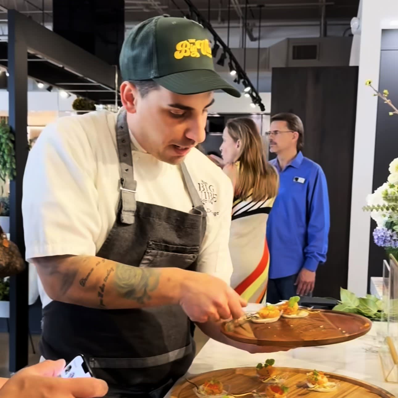 coppa's chef davide plating half arancini, his featured menu item for the chef's night out competition at eggersmann houston's grand re-opening