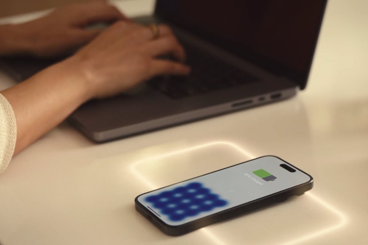 phone wirelessly charging on freepower charging halo invisible device charger in a custom quartz-topped desk